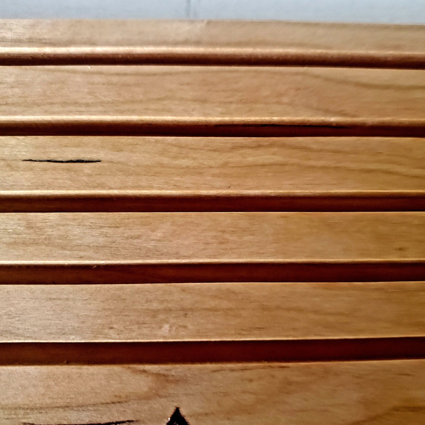 Detailed picture of carved areas for challenge coins on the handcrafted wood desk coin display