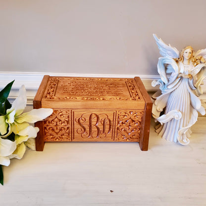 Front view of a handcrafted cherry wood cremation urn featuring a personalized three-letter monogram.