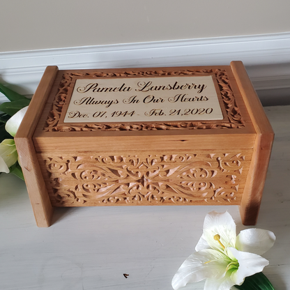 Handcrafted urn with carved details showing the top and front of cremation box