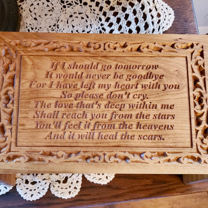 close-up of the personalized monogram engraved on the front panel of the cherry wood urn.